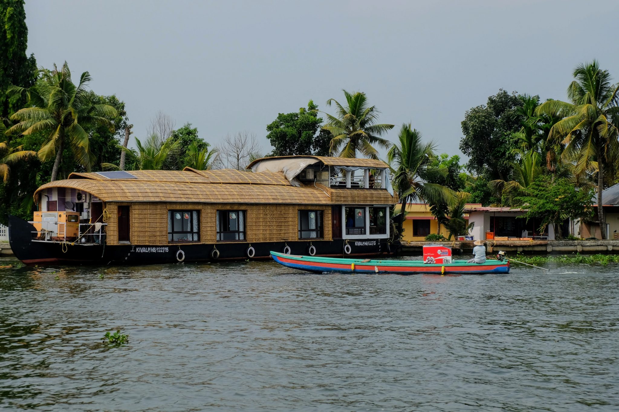 A houseboat and a motorised canoe in Kerala