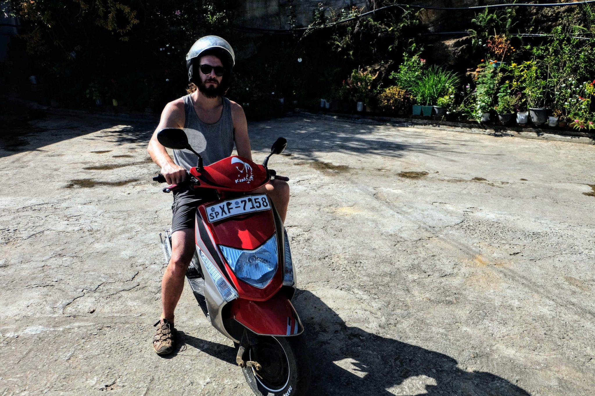 Tourist on a moped at Ravana Falls, Ella, Sri Lanka