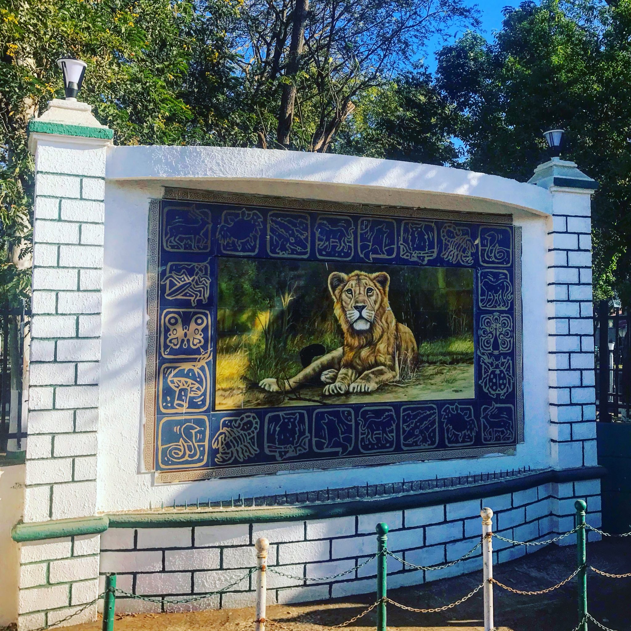 Lion on a Gir National Park sign, Sasan Gir, Gujarat