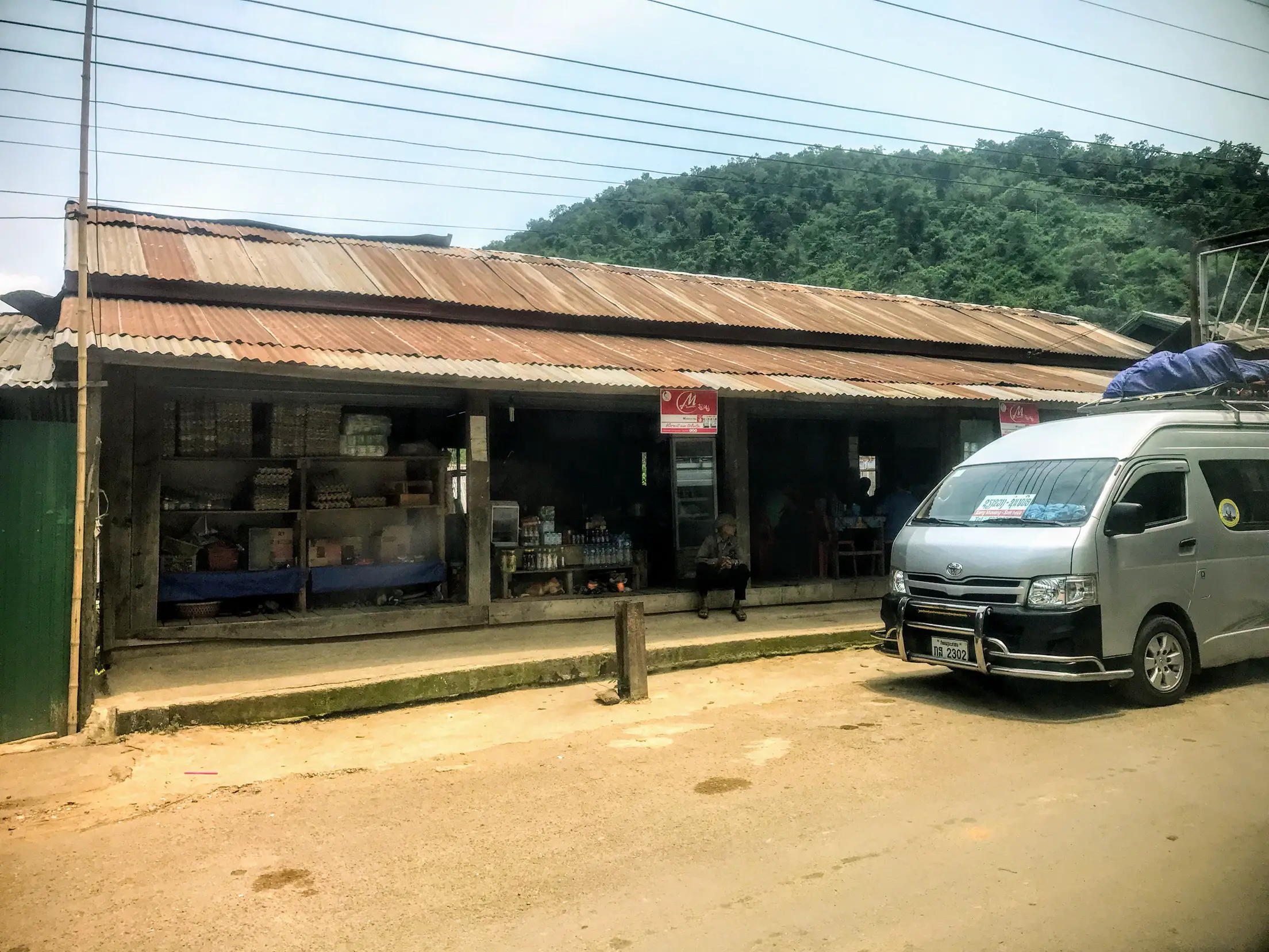 Tourist van outside restaurant, Laos