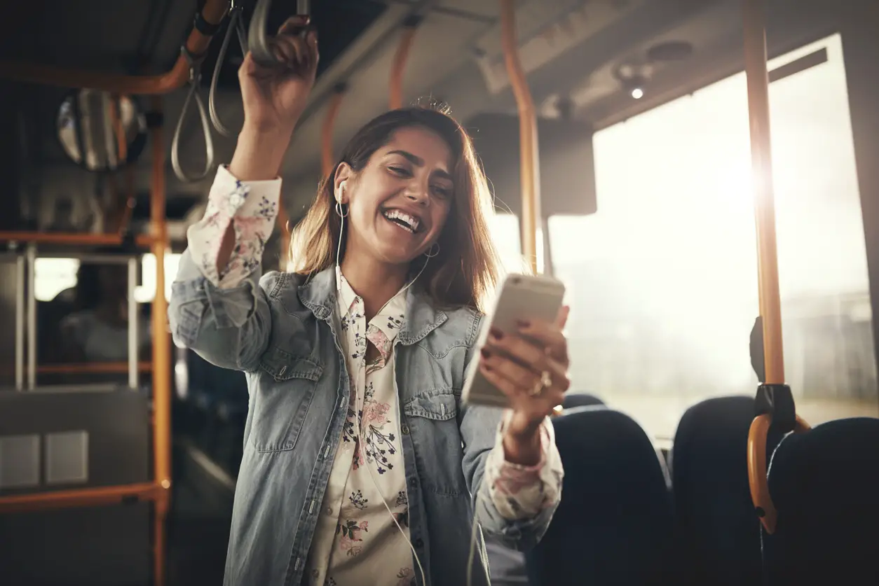 Woman listening to her phone on a bus