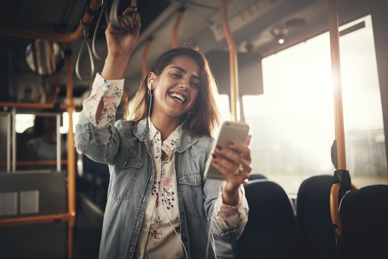 Woman listening to her phone on a bus