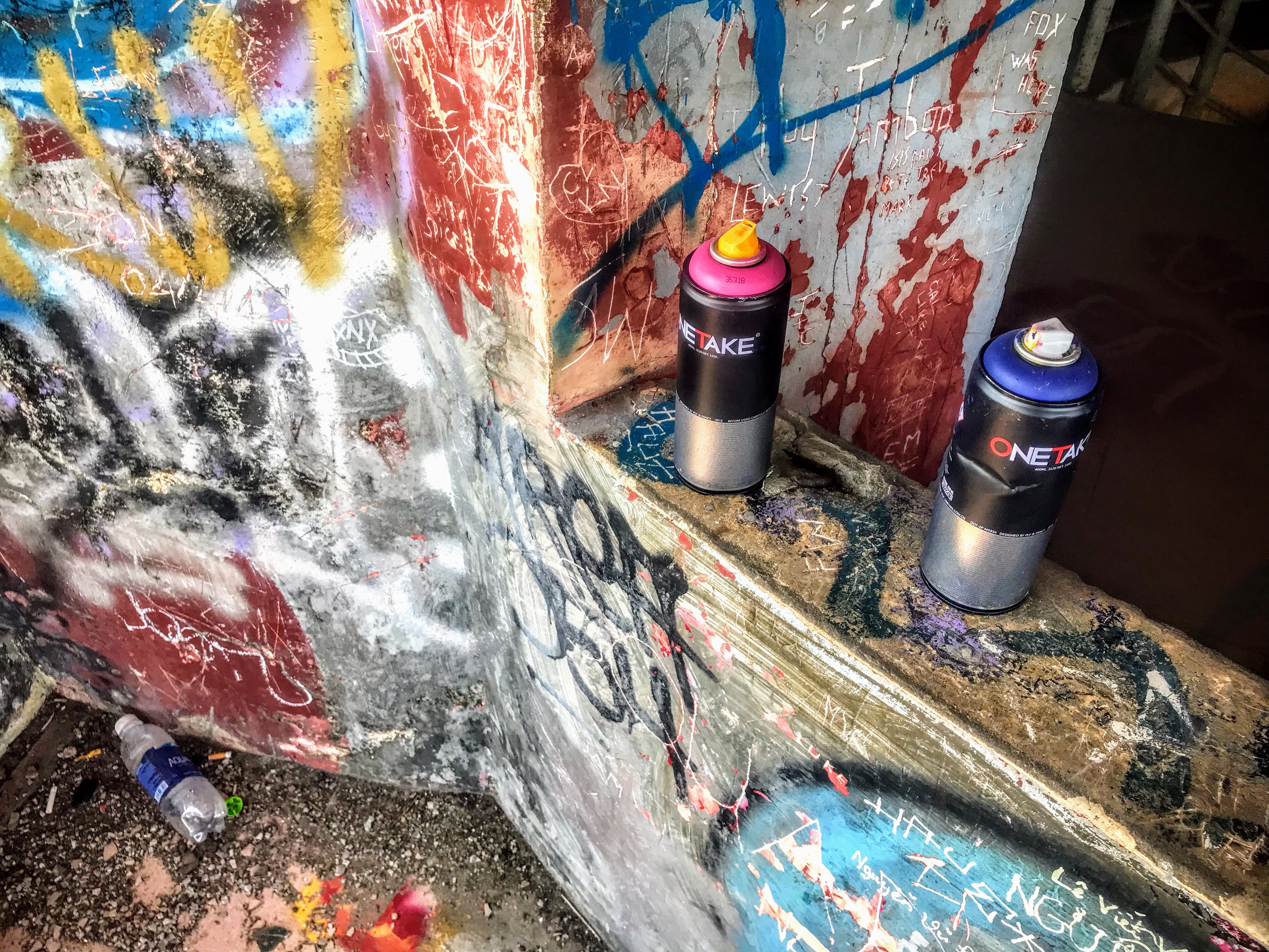 Graffiti cans in Hue’s abandoned waterpark, Vietnam