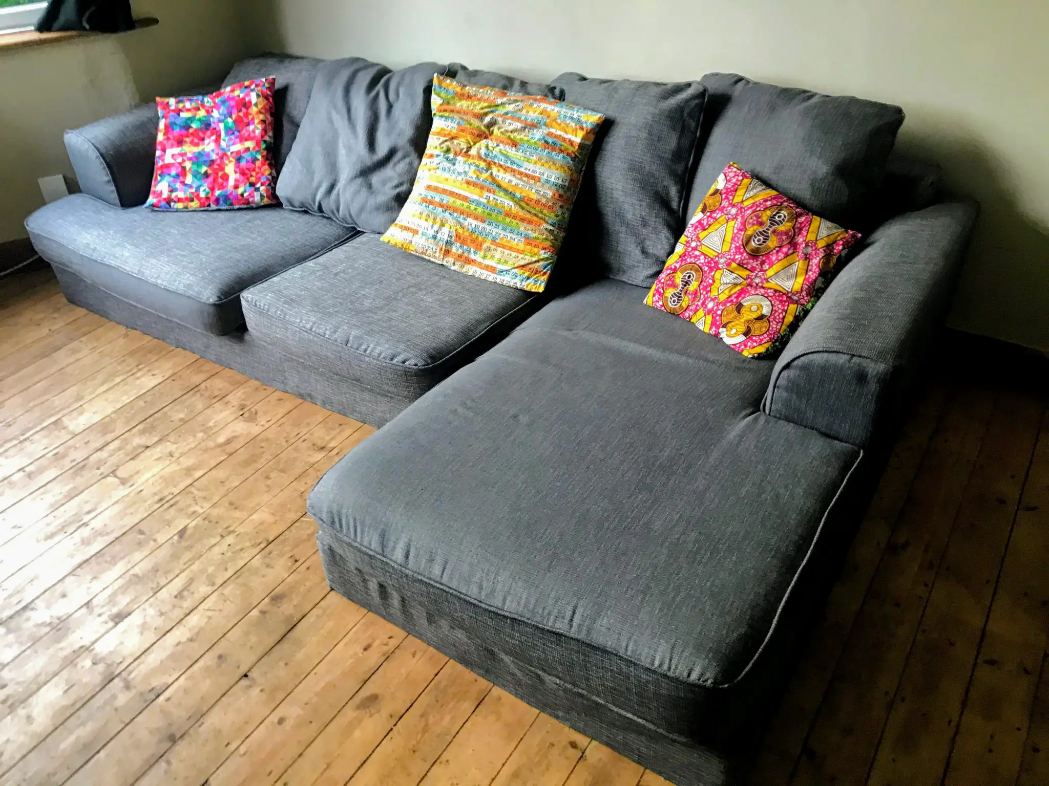 After: Reupholstered grey sofa