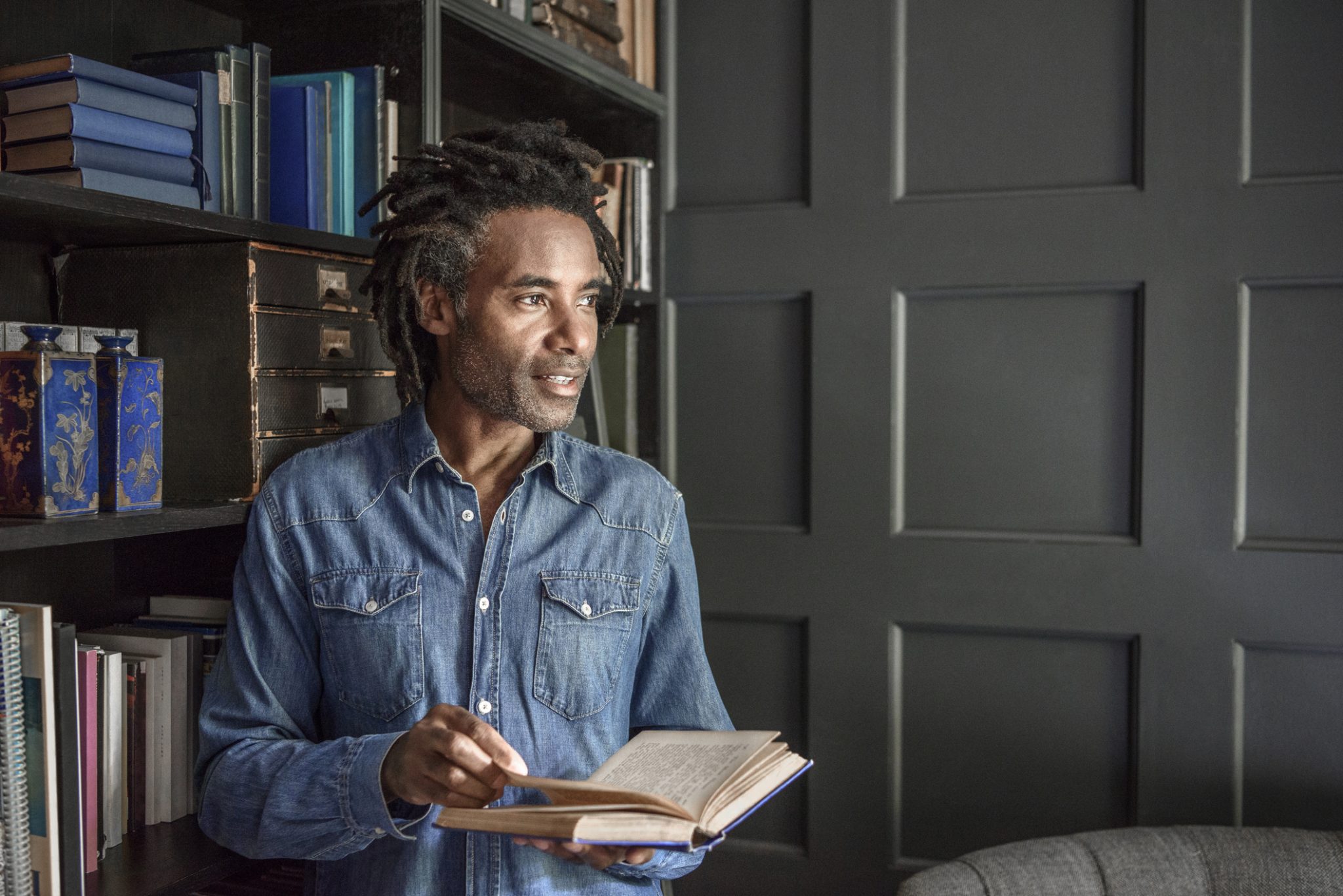 Man reading a book in a library