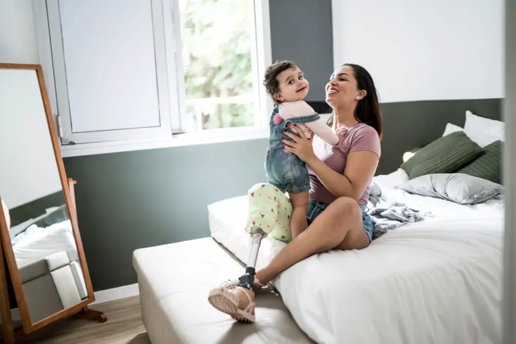 Mother playing with baby at home