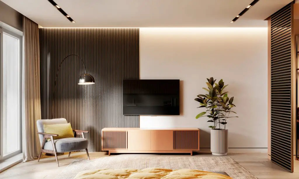 Interior of a bedroom with armchair and tv on wall